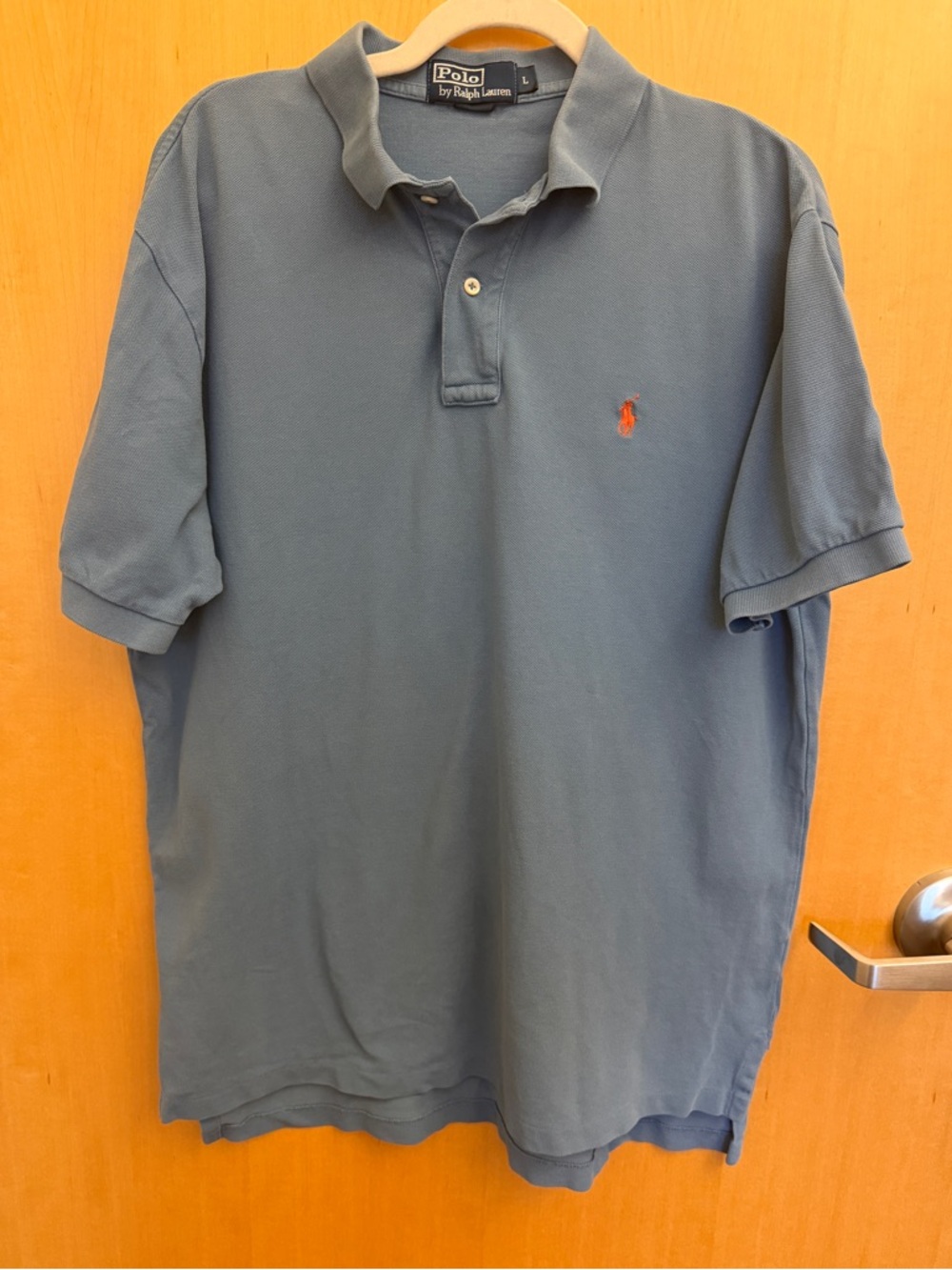 Light blue Ralph Lauren polo shirt with orange pony. Size large